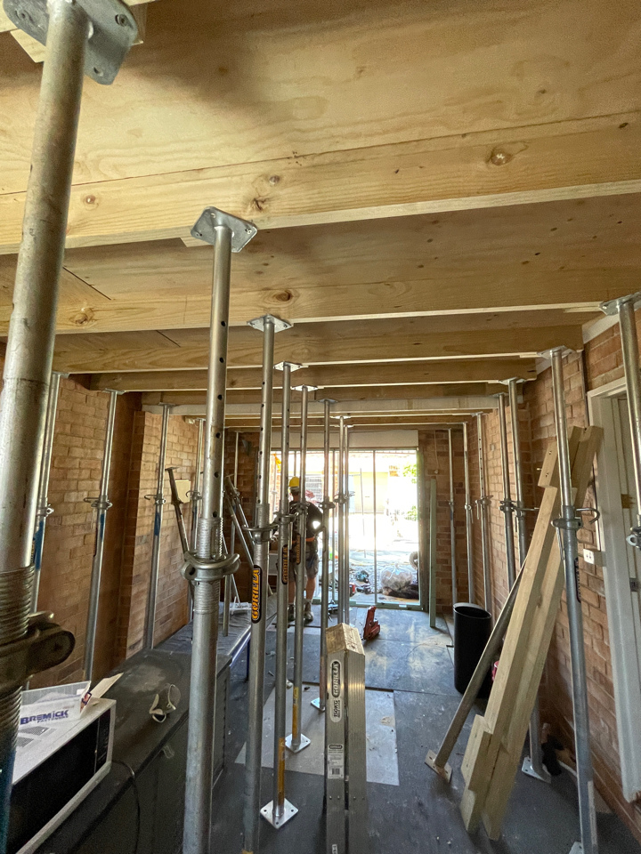 Grid of acrow props propping a full room while structural works are carried out