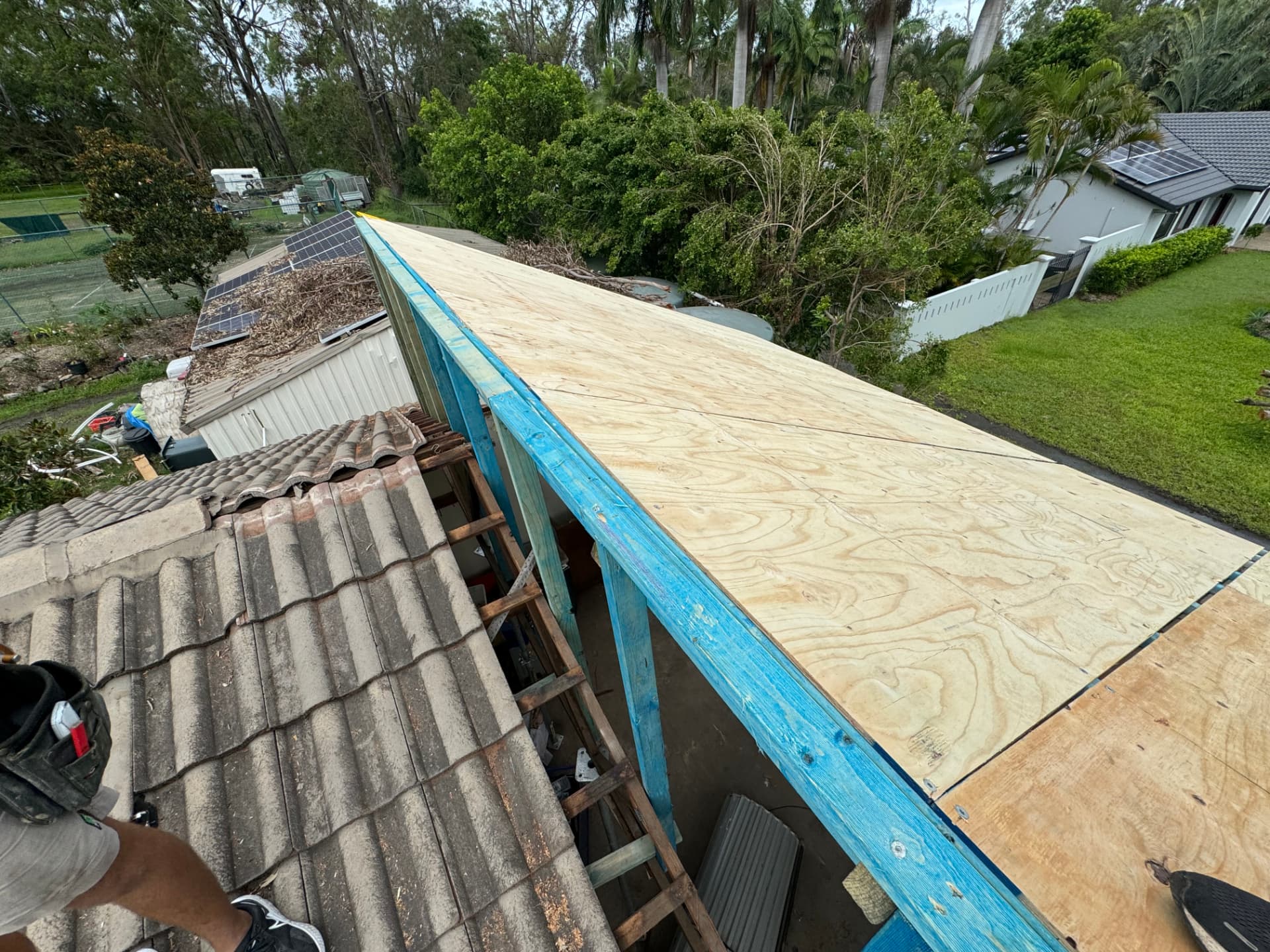 Completed ply roof deck running to the ridge alongside the existing tiled roof